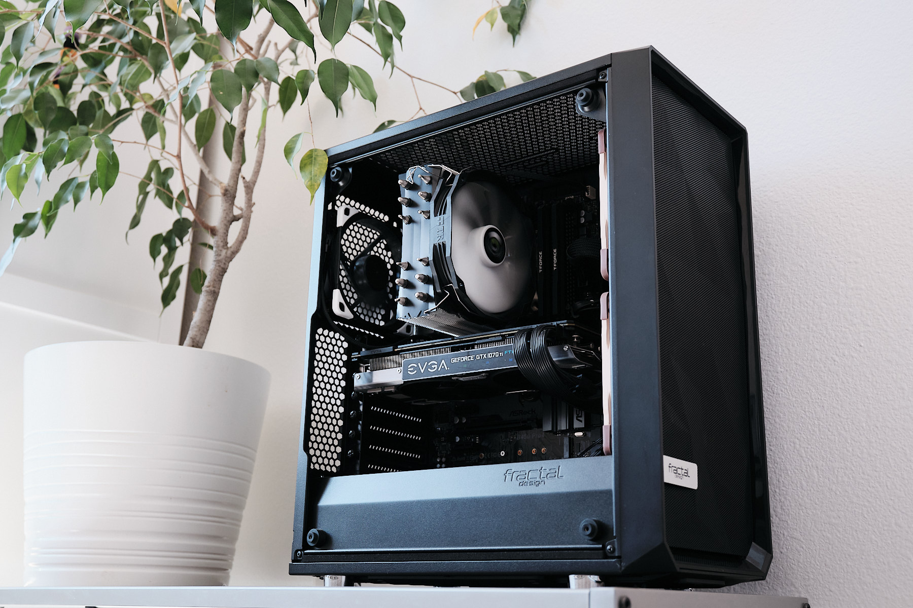 A Fractal Design PC case with the side panel removed, showing an EVGA GeForce GTX 1070 Ti GPU and CPU cooler